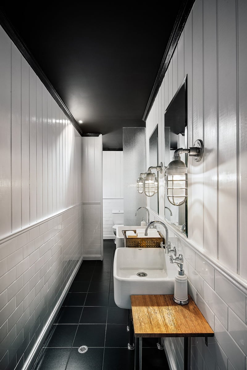 Atomic Industrial Guard Sconces in Long White Bathroom